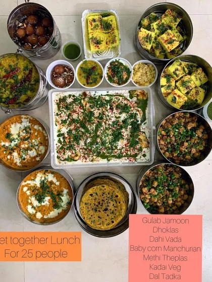Another angle of the get-together lunch, highlighting the colorful Dahi Vada and other delicious items.