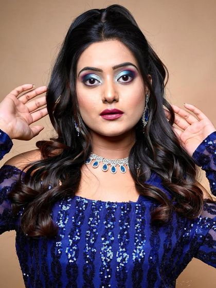 A vibrant blue and purple smokey eye paired with a bold magenta lip. I teach my students to be fearless with color.