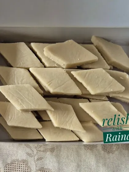 A box of Kaju Katli without the silver vark, as requested by a client. The focus is on the pure, authentic taste of cashews.