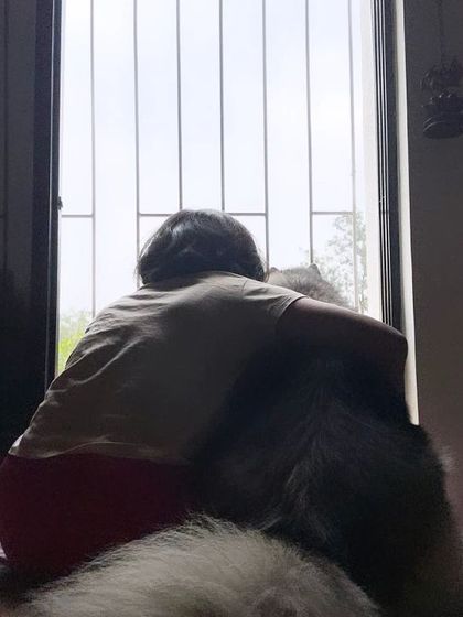 A slightly different angle of the hug by the window, emphasizing the feeling of comfort and safety in the embrace.