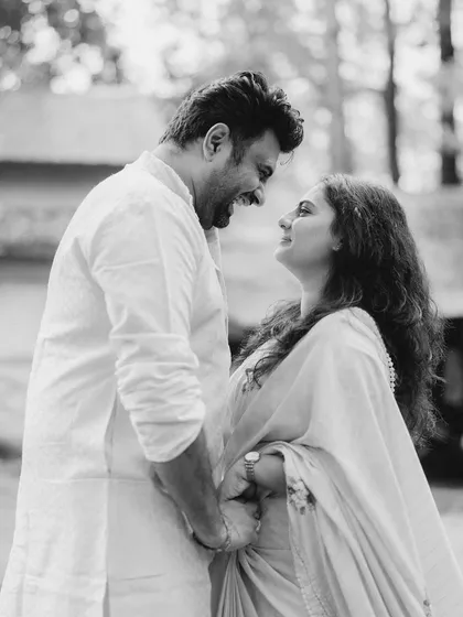 A beautiful black and white shot capturing a moment of shared laughter. The way they look at each other shows a deep connection and a friendship at the heart of their love.
