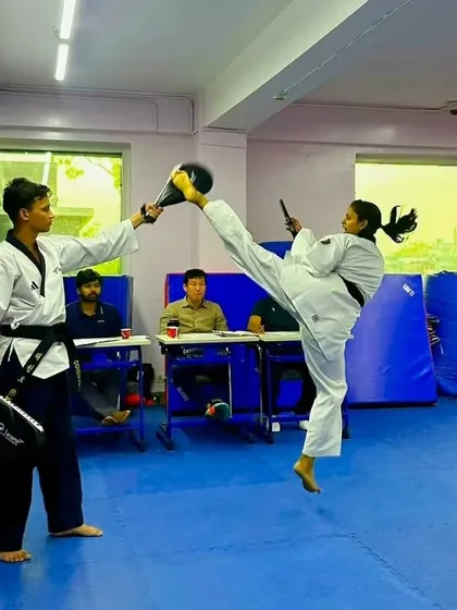 The pursuit of perfection in every move. Here, our black belt student Vanshika demonstrates a flawless high kick during a technique drill, showcasing the flexibility and precision required for scoring at the highest levels.