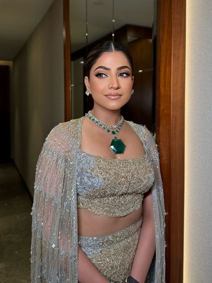 Another angle of this graceful look. The makeup is subtle yet impactful, perfect for any formal occasion.