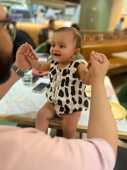 Capturing those precious, happy moments. This little one is all smiles in our black and white printed cotton romper. I make sure my infant wear is incredibly soft on delicate skin and easy for parents to manage, with simple openings for quick changes.