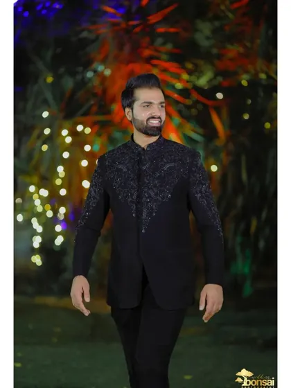 A candid shot of the groom smiling, capturing his happiness and excitement on his wedding day.