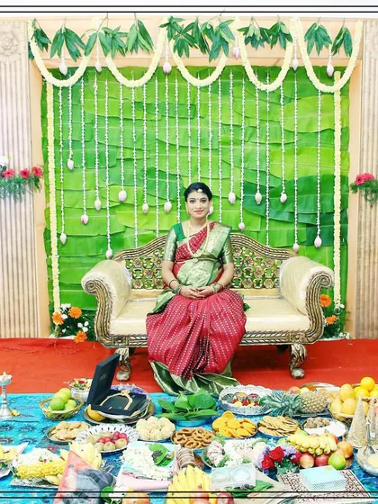 We create serene and traditional setups for baby showers, like this Seemantham ceremony. The decor features a backdrop of banana leaves and jasmine garlands, with a comfortable space for the mother-to-be and the ceremonial offerings.