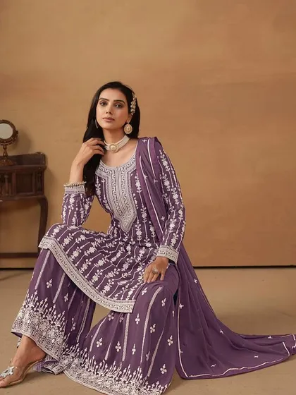 A regal purple salwar kameez with intricate white thread embroidery. The georgette fabric gives it a beautiful flow, making you feel like a queen.