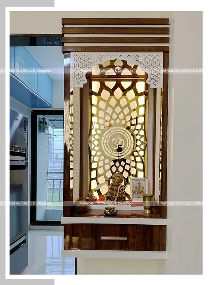 Another view of the compact pooja unit with CNC jali work. This photo shows how the backlighting creates a warm and divine glow, making the 'Om' symbol and the entire unit stand out.