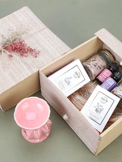 This is a product shot of a wellness-themed gift box containing essential oils and a diffuser. We focus on capturing the serene and premium nature of such products for brands in the beauty and wellness space.