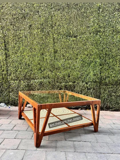 A clear shot of the coffee table against a green wall.