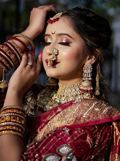 A close-up of a classic Maharashtrian bride. I specialize in perfecting every detail, from the `Chandrakor` bindi to the soft, glowing skin that complements the rich textures of the `Navari` saree.