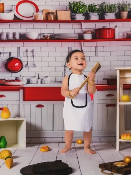 This little chef is ready to cook up a storm. We encourage playful interaction with props to get the most natural and fun shots.