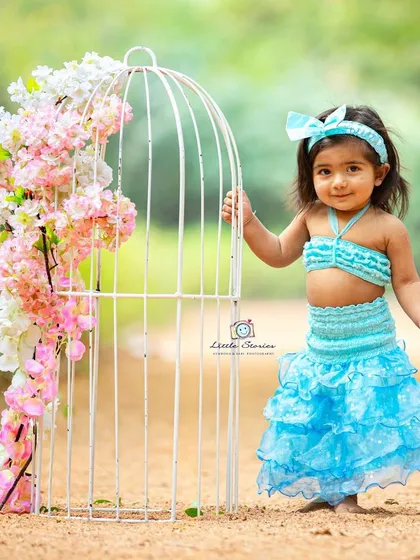 A touch of fantasy. This mermaid-inspired outfit and floral prop combination creates a unique and imaginative portrait.