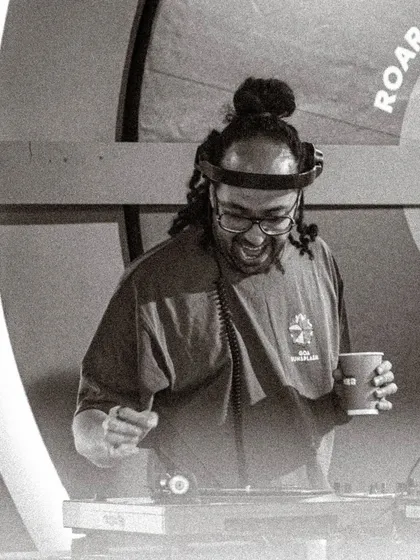 A black and white shot of me enjoying the moment while spinning records at an outdoor festival. These pop-ups are a passion project, and that genuine vibe comes through.