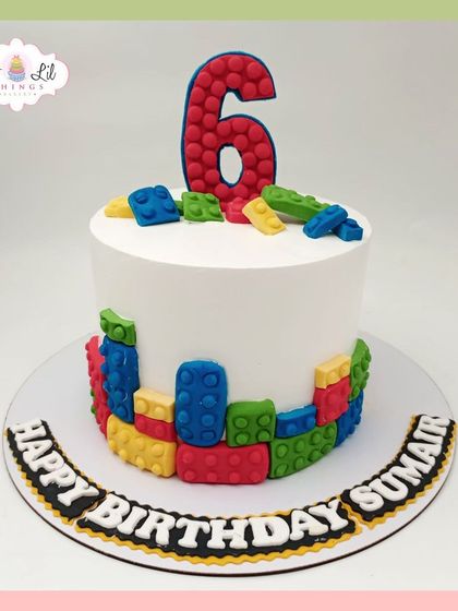 A simple yet fun LEGO cake for Sumair's 6th birthday, with colorful blocks decorating the base and a big number 6 on top.