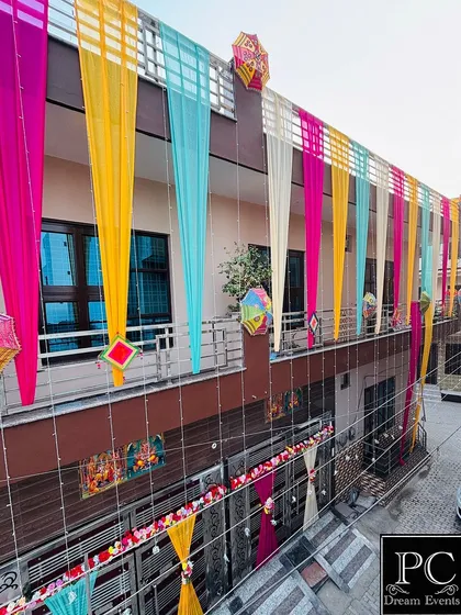 This wide shot captures the full extent of the home decoration, including the entrance gate and the multiple balconies, all tied together with a consistent, colorful theme.