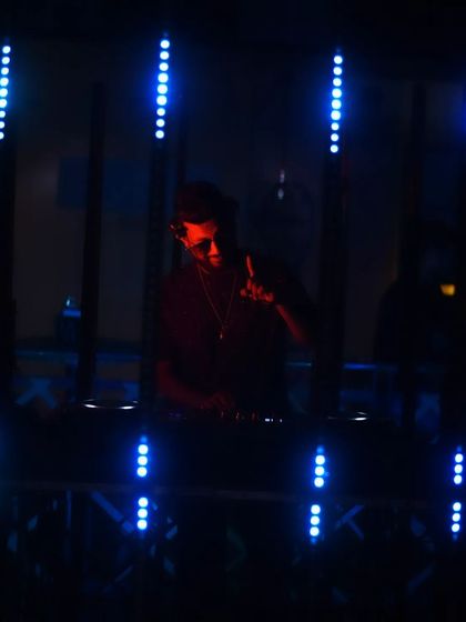 A darker, silhouetted shot against the blue lights.