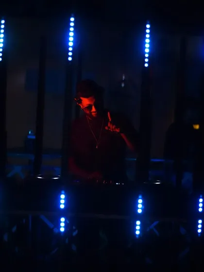A darker, silhouetted shot against the blue lights.