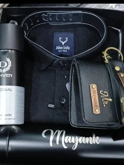 Another variation of the all-black gift hamper, featuring a personalized temperature bottle, wallet, and keychain with different charms, a shirt, and deodorant.