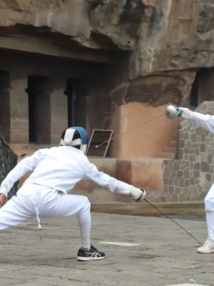 A close up of an exchange, showing one fencer's lunge being met by the opponent's parry. This demonstrates the quick thinking required in a bout.
