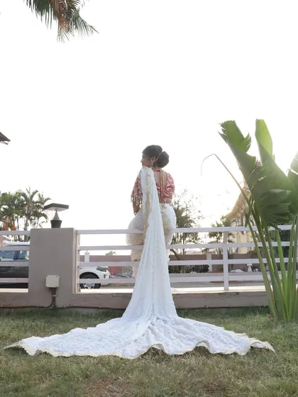 Another view of the bride with her magnificent saree train, showcasing the full effect of her grand bridal outfit.