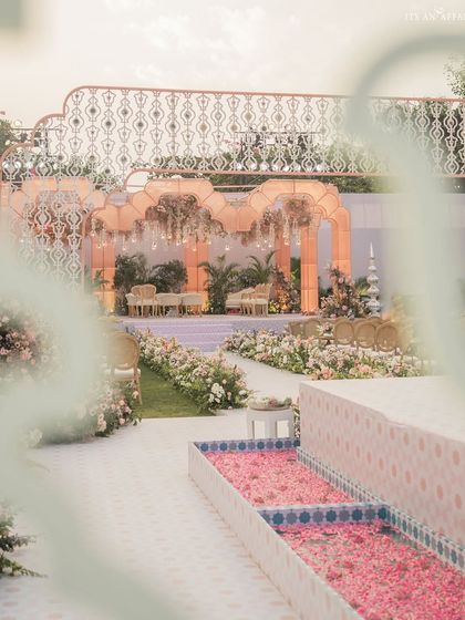 A view of the 'Gulab Bagh' wedding aisle, flanked by a water channel filled with rose petals, leading towards the ethereal organza mandap.