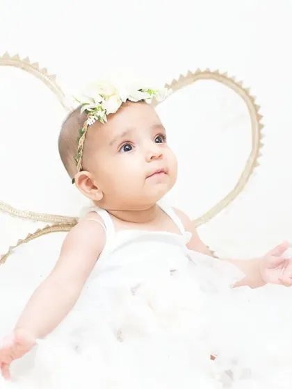 This little angel is sitting among the clouds. My angel wing and cloud theme creates a dreamy and ethereal portrait.