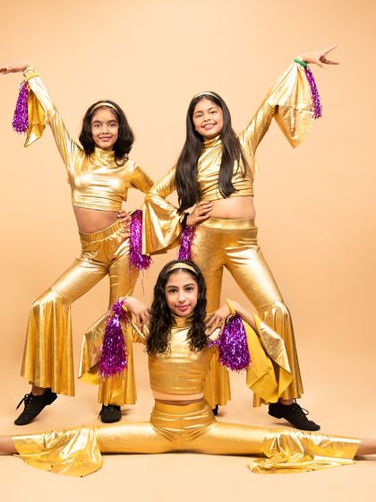 Bringing the funk with our kids' disco jazz performance. Dressed in gold, these young dancers are ready to boogie with pointed fingers, popping hips, and infectious energy.