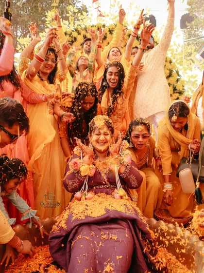 The pure, unfiltered joy of a Haldi ceremony. We love capturing these high-energy moments, with friends and family showering the bride in flower petals. It’s all about real smiles and vibrant colours.