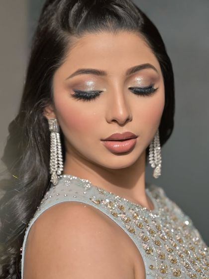 A close-up of a silver glam look, showing the detailed eyeshadow work with glitter and a flawless airbrush base. This is perfect for a cocktail party or reception.
