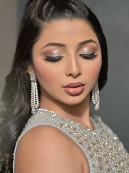 Another angle with eyes closed, highlighting the detailed eyeshadow work and the long, voluminous lashes.