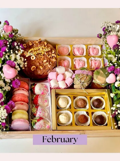 Gifting is an art, and our luxury hampers are our masterpiece. This Valentine's Day hamper was curated with love, featuring a chocolate smash heart, macarons, chocolate-dipped strawberries, and artisanal truffles, all nestled amongst fresh flowers.
