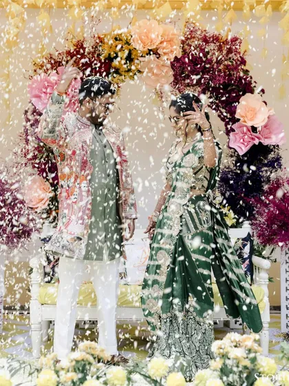 Another shot of the couple's energetic dance performance, with confetti filling the air around them.