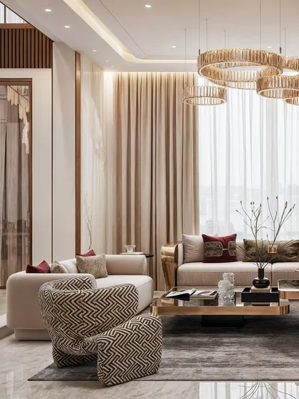 A wide shot of the living area, highlighting the multi-ring chandelier and the cohesive color palette of beige, brown, and gold.