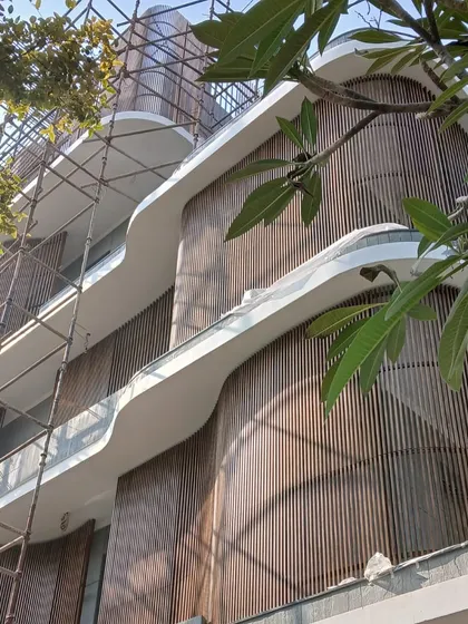 A work in progress, the Rudra Residence in Kanpur breaks from the traditional bungalow form. The sweeping curves and vertical wooden screens are part of a bold experiment in form and material.
