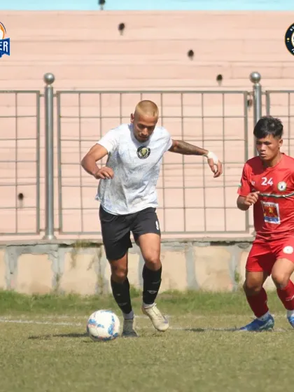 A player dribbles past an opponent, showcasing skill and attacking intent.