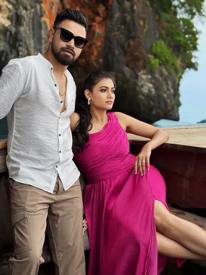 A stunning shot from a destination pre-wedding shoot in Thailand. The bride's vibrant dress and natural makeup look beautiful against the dramatic landscape.