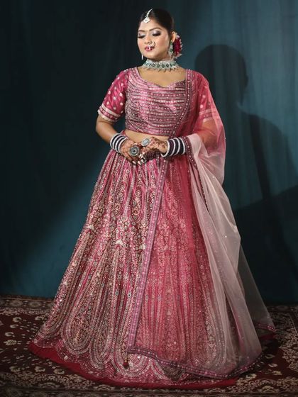 A full-length shot of this gorgeous pink bridal lehenga. It comes with a double dupatta to give you a complete and royal bridal look.