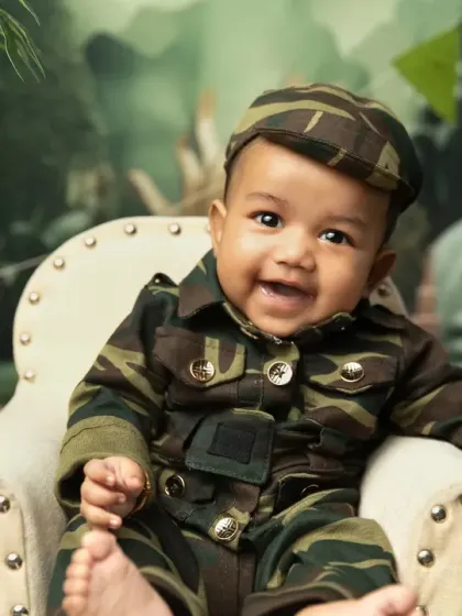 A close-up of our little soldier's infectious grin. These photos are full of personality and pride.