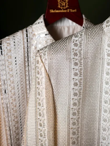 A close-up of the shoulder and sleeve of our embroidered sherwanis. It highlights the years of skill passed down and perfected, reflected in every single stitch.