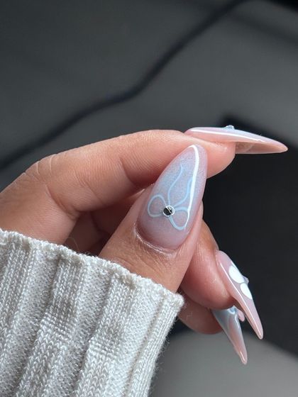 An ethereal and delicate design. This set features a soft, cloudy blue and white base with hand-painted white bows and a 3D flower, perfect for a soft-girl aesthetic.