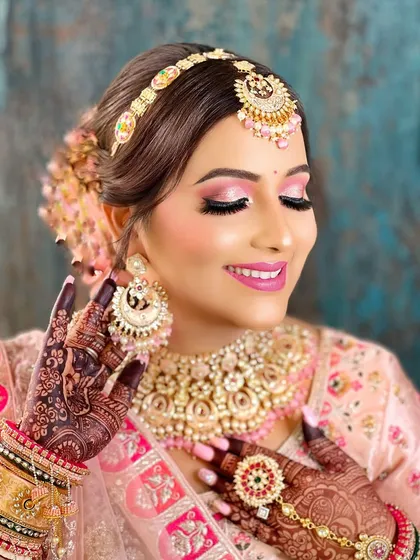 A final, radiant shot of the bride in pink. The glass-finish makeup and the sparkling Kundan jewellery create a flawless and memorable look.