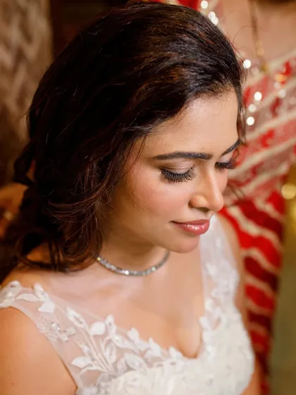 A close-up on the soft, smokey eye and flawless skin. This look is elegant and timeless, perfect for a classic white wedding.