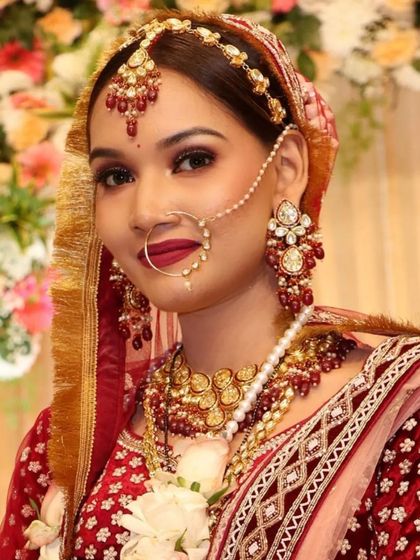 A portrait of the bride, highlighting the intricate details of her matha patti, earrings, and nath.
