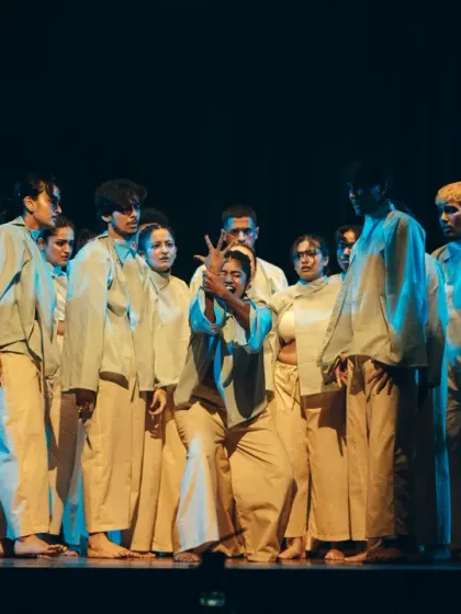 A theatrical and emotive group pose under the stage lights, highlighting the storytelling aspect of our dance pieces.