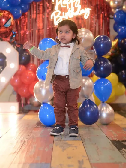 The birthday boy looking dapper and excited for his Spiderman-themed party.