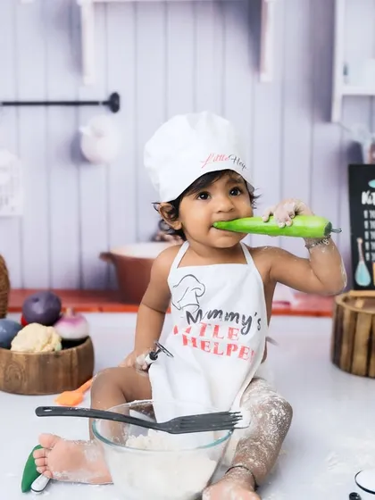 Who needs a spoon? This "Mommy's Little Helper" is taste-testing the equipment in her adorable chef photoshoot.
