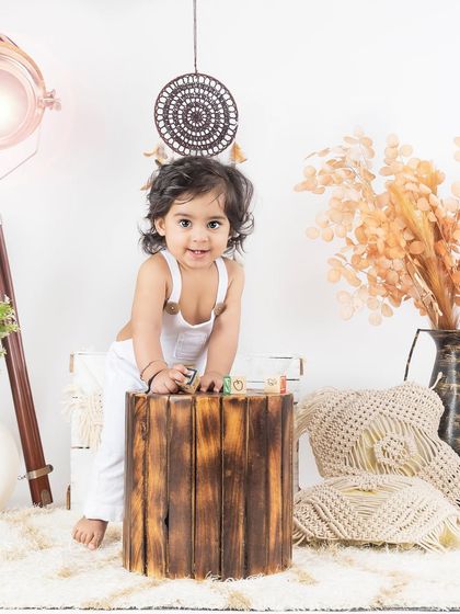 This little one is playing with wooden blocks in our neutral-toned lifestyle setup.