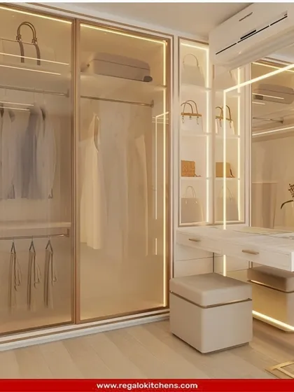 A beautiful combination of a wardrobe and vanity. The glass doors are framed with light, and the matching vanity station creates a cohesive and glamorous getting-ready space.