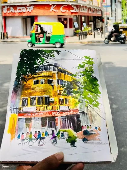My finished painting of the KC Das building on Church Street, held up against the real location. The yellow of the building is so iconic.
